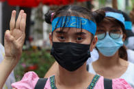 An anti-coup protester flashes the three-fingered salute while wearing a headband that reads R2P, which means Responsibility to Protect, during a gathering in Ahlone township in Yangon, Myanmar Monday, April 12, 2021. The protesters have called for foreign intervention to aid them under the doctrine of Responsibility to Protect, or R2P, devised to deal with matters such as genocide, war crimes, ethnic cleansing and crimes against humanity. (AP Photo)