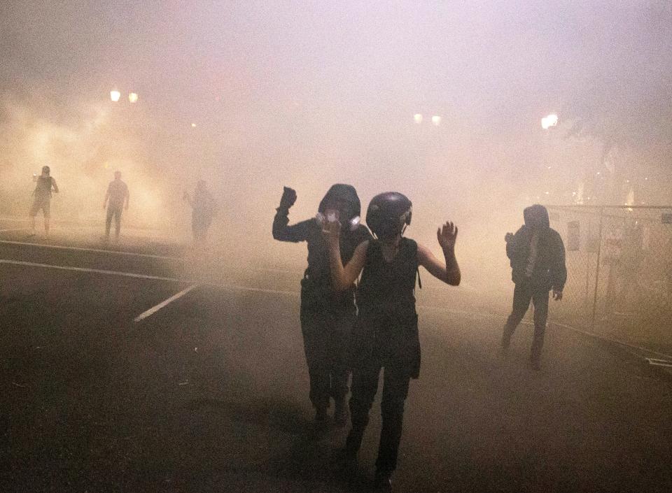 Protesters gather during a demonstration in Portland, Oregon, Thursday, July 16, 2020.  Federal officers deployed tear gas and fired less-lethal rounds into a crowd of protesters late Thursday.  The actions came just hours after the head of the Department of Homeland Security called the protesters “violent anarchists.”