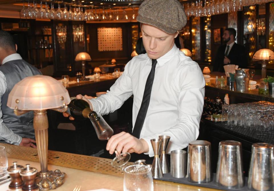 Freddie Fox pours the drinks at The Ivy (Photo Dave Benett/Getty Images)