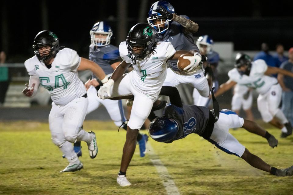 Choctaw's Isaiah Johnson (No. 1) breaks free from the Washington defense to pick up extra yards during Thursday night's prep football matchup.