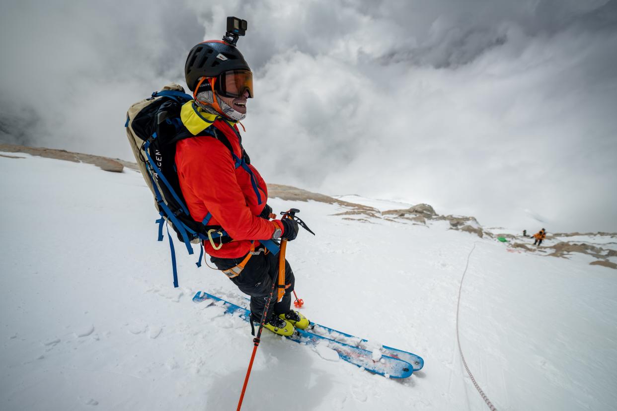 adrian ballinger wearing a red ski jacket and skis on the side of Makalu