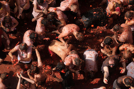 Revellers throw tomatoes during the annual "Tomatina" festival in Bunol, near Valencia, Spain, August 29, 2018. REUTERS/Heino Kalis