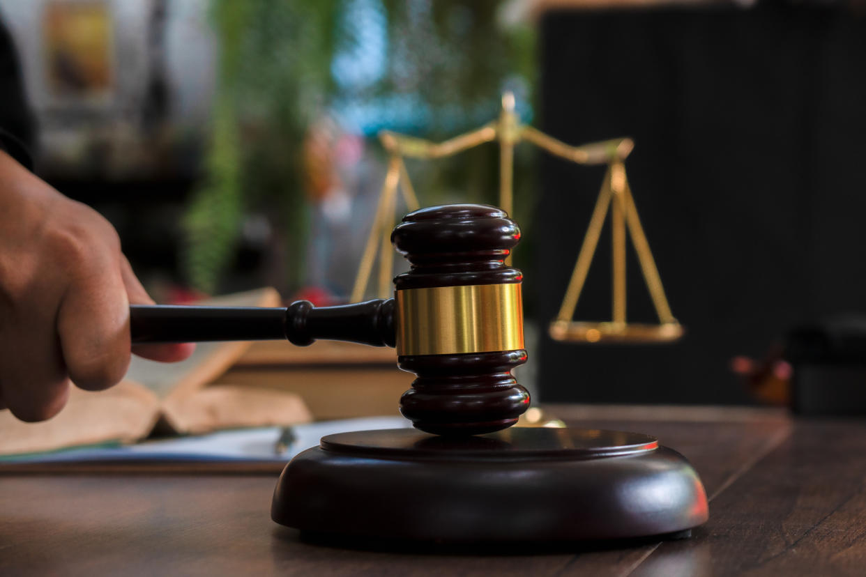 An image showing a judge's gavel, scales, hourglass and books, to illustrate a story on the ex-CEO of Hyflux being charged in court. 