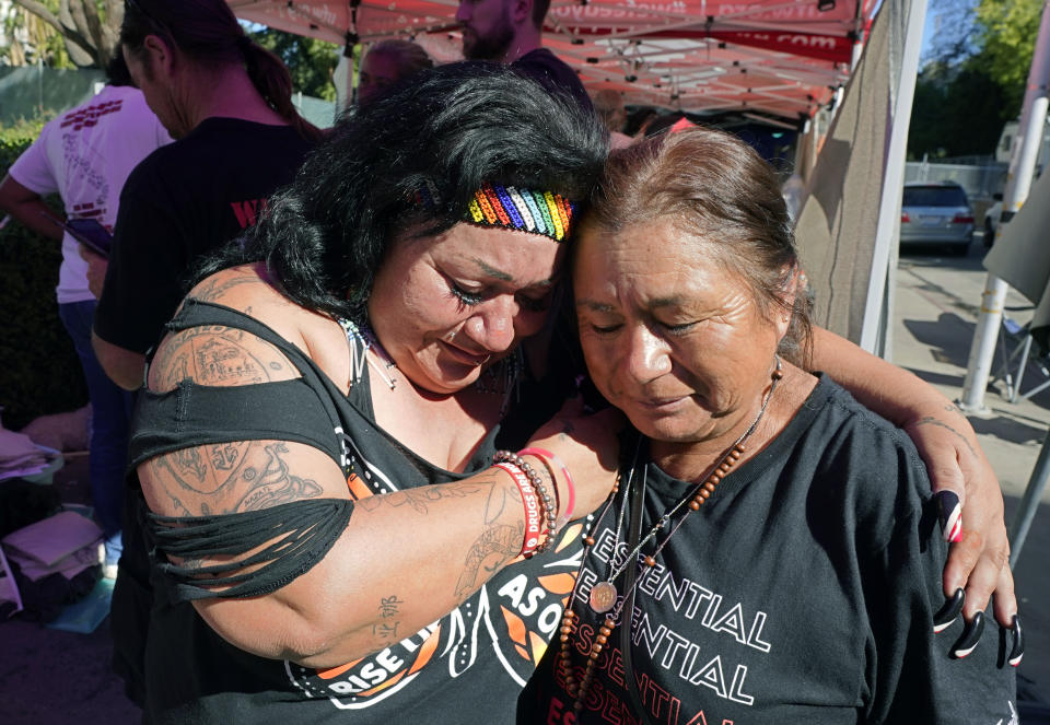 FILE - Farmworkers Cynthia Burgos, left and Teresa Maldonado, right, hug after Gov. Gavin Newsom signed a bill aimed at making it easier for farmworkers to unionize in Sacramento, Calif., Sept. 28, 2022. A battle between The Wonderful Co., which grows pistachios, pomegranates, citrus and other crops and United Farm Workers is over new rules in California aimed at making it easier for farmworkers to form unions. (AP Photo/Rich Pedroncelli, File)