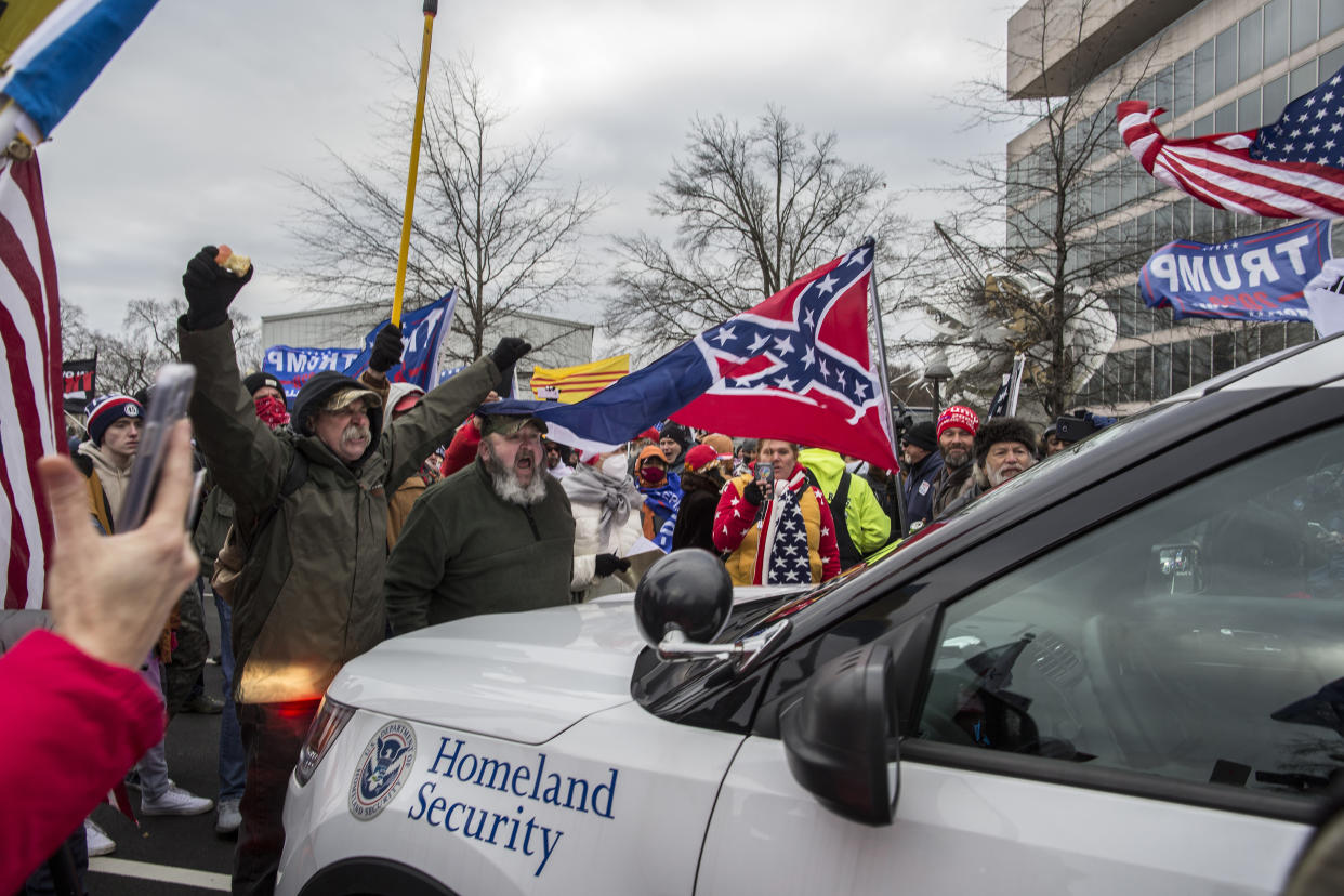 WASHINGTON, DISTRICT OF COLUMBIA, UNITED STATES - 2021/01/06: US President Donald Trumps supporters push back a police car while gathering outside the Capitol Building. Pro-Trump rioters stormed the US Capitol as lawmakers were set to sign off Wednesday on President-elect Joe Biden's electoral victory in what was supposed to be a routine process headed to Inauguration Day. (Photo by Probal Rashid/LightRocket via Getty Images)