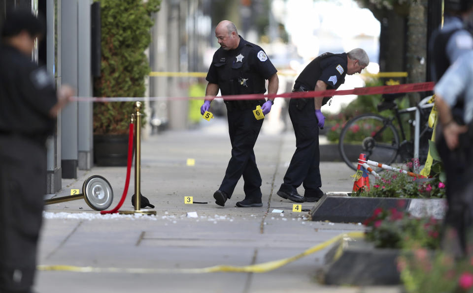 Chicago police investigate the scene of a shooing Tuesday, Aug. 4, 2020, on Oak Street in Chicago. The shooting left one person dead and two inured, authorities said. (Chris Sweda/Chicago Tribune via AP)