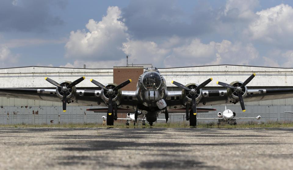 FILE - In this July 17, 2013 file photo is the B-17G "Yankee Lady" in front of the old Willow Run Bomber Plant at Willow Run Airport in Ypsilanti Township, Mich. At President Franklin Roosevelt's urging, Ford Motor Co. switched from making cars to planes at the factory which employed 40,000 men and women who produced one an hour _ nearly 9,000 B-24 Liberator bombers in all _ to help win the World War II. Closed for good in the last decade, the plant is scheduled to be knocked down. A group trying to save the factory from demolition announced Friday, March 28, 2014, it has raised $6.5 million, but it needs $8 million and has until May 1 to make that happen. (AP Photo/File)