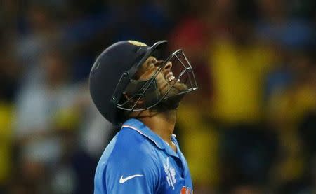 India's Rohit Sharma reacts after being bowled out by Australia's Mitchell Johnson during their Cricket World Cup semi-final match in Sydney, March 26, 2015. REUTERS/David Gray