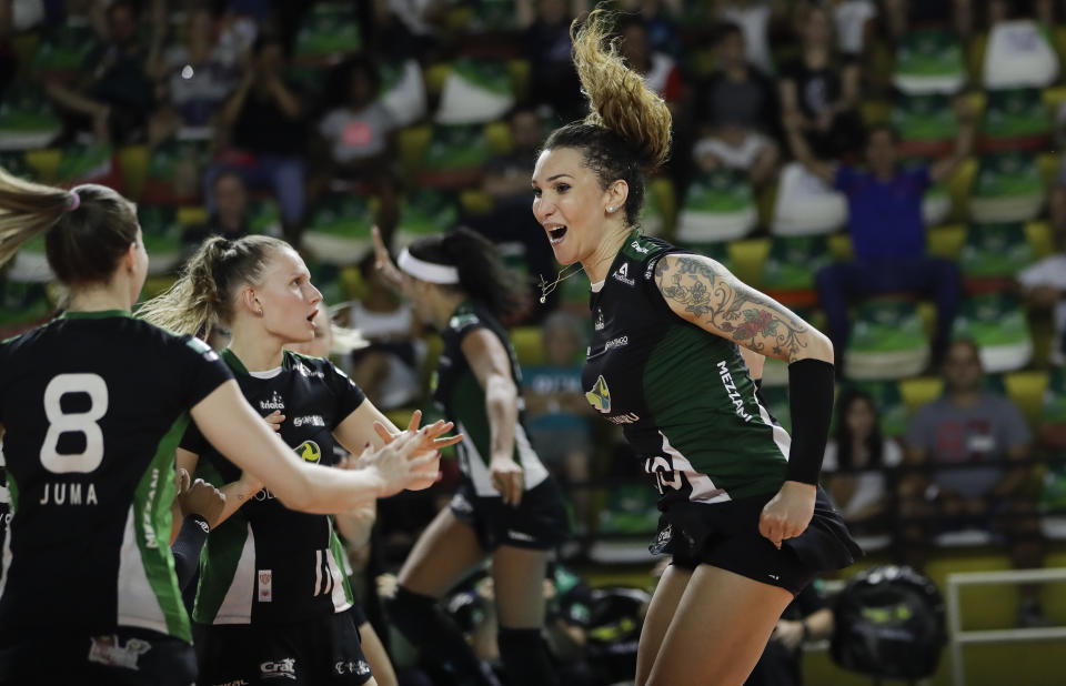 FILE - In this Tuesday, Dec. 19, 2017 file photo, Bauru's volleyball player Tiffany Abreu, right, celebrates with teammates during a Brazilian volleyball league match in Bauru, Brazil. Abreu became the first transgender player in the top women's volleyball league in 2017. Her record-setting performances have rankled Ana Paula Henkel, a four-time Olympian for Brazil in volleyball and beach volleyball. She vented her feelings in an open letter to the IOC in December, contending its policy was unfair. (AP Photo/Andre Penner)