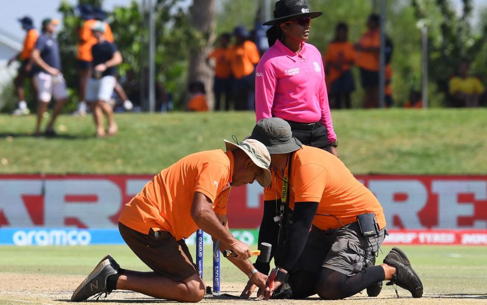 Technical personnel work on the pitch during the Group B T20 women's World Cup cricket match between Ireland and England at Boland Park in Paarl on February 13, 2023. - RODGER BOSCH/AFP via Getty Images