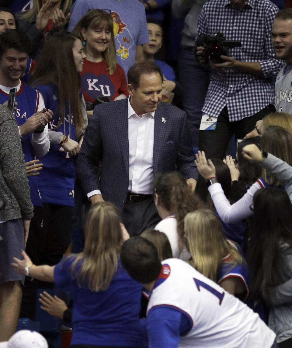 New Kansas football coach Les Miles greets fans during halftime of an NCAA college basketball game against Stanford in Lawrence, Kan., Saturday, Dec. 1, 2018. (AP Photo/Orlin Wagner)