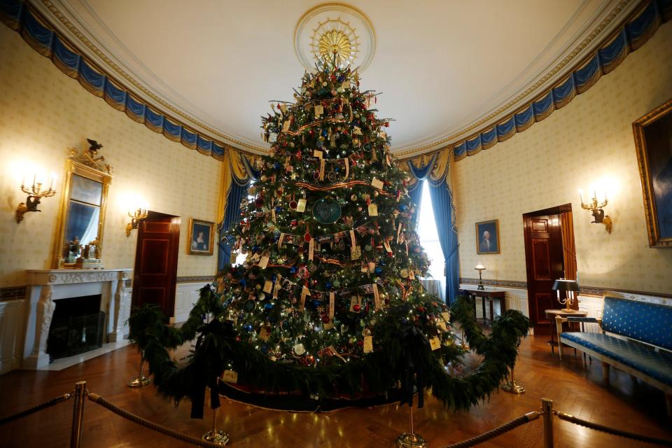A highly decorated Douglas fir tree in the Blue Room of the White House