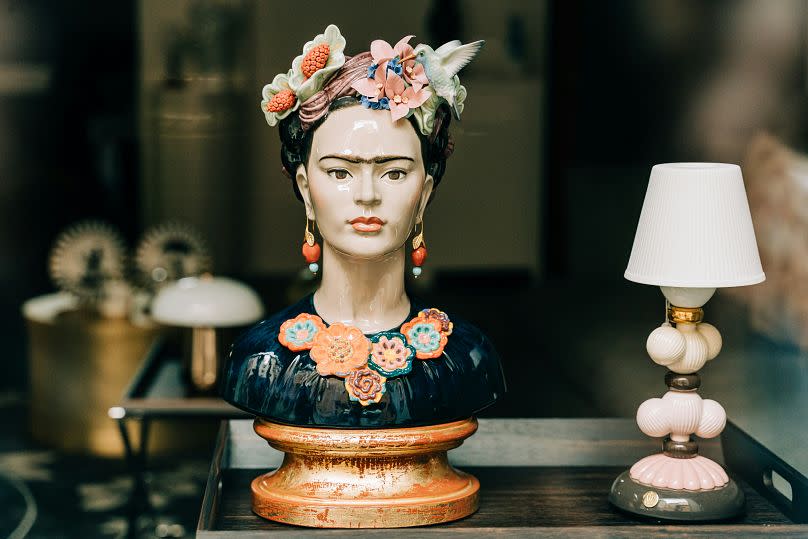 Red lips, black eyes, a monobrow, and dark hair decorated with flowers – you can immediately tell it's Kahlo.