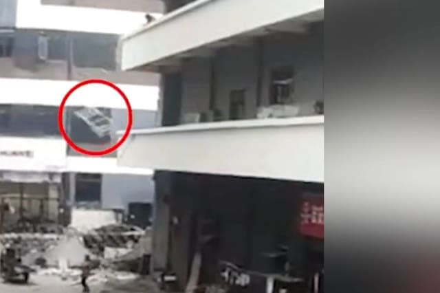 Chinese woman miraculously survives after being hit by iron bed frame thrown out of building