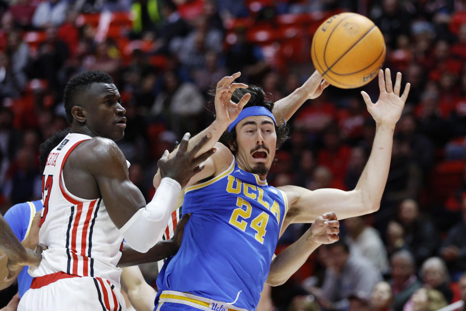 Utah center Keba Keita, left, and UCLA guard Jaime Jaquez Jr. (24) watch the ball get away during the second half of an NCAA college basketball game Thursday, Feb. 23, 2023, in Salt Lake City. (AP Photo/Jeff Swinger)