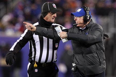 Nov 24, 2013; East Rutherford, NJ, USA; New York Giants head coach Tom Coughlin argues with head linesman Steve Stelljes (22) during the third quarter of a game against the Dallas Cowboys at MetLife Stadium. Mandatory Credit: Brad Penner-USA TODAY Sports