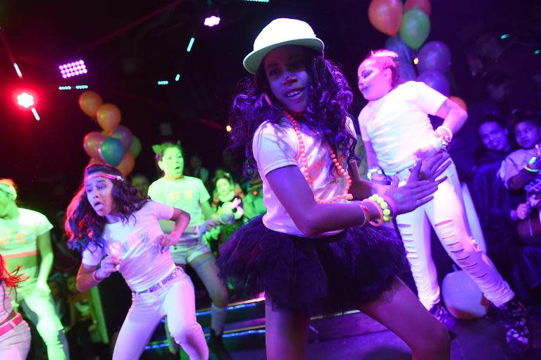 Children dance during an electronic dance music party at a night club in New York on October 26, 2014