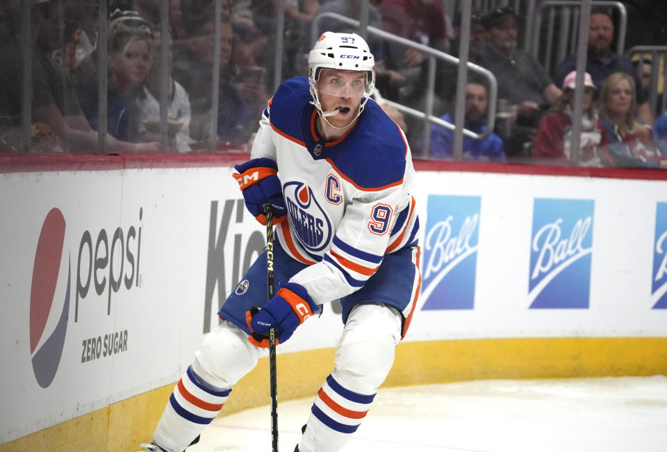 Edmonton Oilers center Connor McDavid collects the puck behind the net during the second period of the team's NHL hockey game against the Colorado Avalanche on Tuesday, April 11, 2023, in Denver. (AP Photo/David Zalubowski