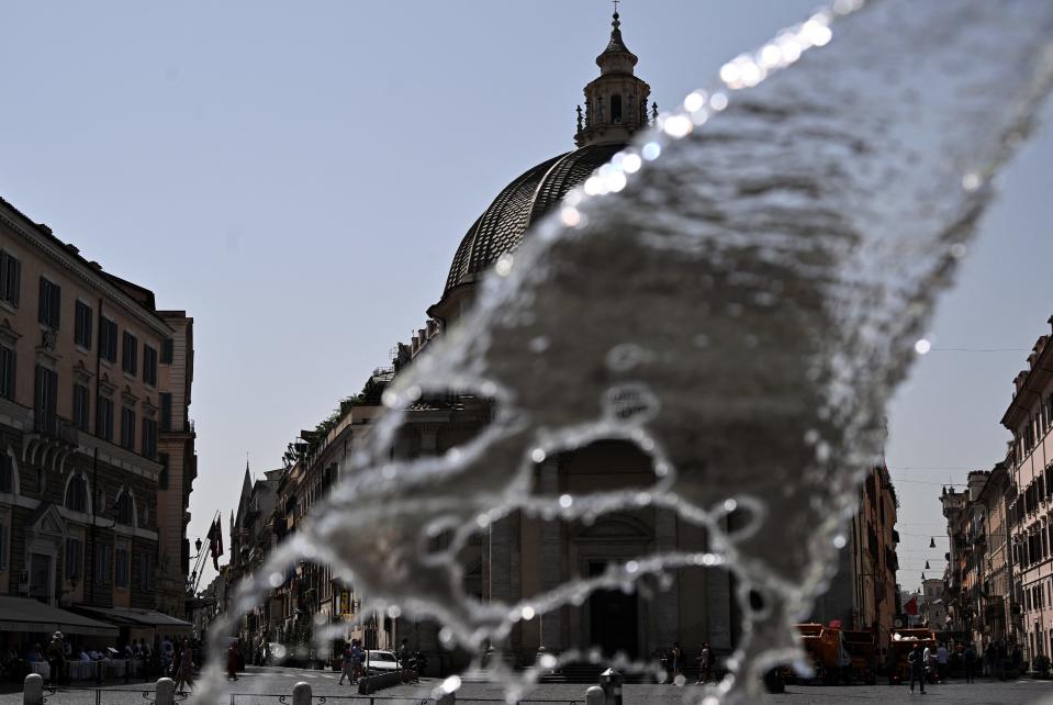 A photo shows water from a fountain on the Piazza del Popolo in central Rome on July 17, 2023.