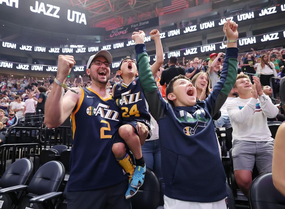 Mike Shackelford cheers with his sons Lucas and Ethan as the Utah Jazz choose Taylor Hendricks as their first pick during the draft fan event in Salt Lake City on Thursday, June 22, 2023 and the NBA draft. | Jeffrey D. Allred, Deseret News