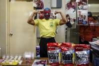 A man poses for a pictures as he sells High protein foods outside a Stardom female professional wrestling show at Korakuen Hall in Tokyo, Japan, December 23, 2015. REUTERS/Thomas Peter