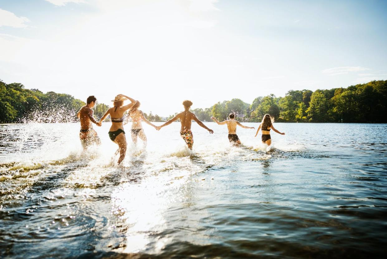 <span class="caption">Engaging with people who accept and appreciate your body as it is can help you feel more at peace with how you look.</span> <span class="attribution"><a class="link " href="https://www.gettyimages.com/detail/photo/friends-wading-into-lake-in-summer-sun-royalty-free-image/1049718960" rel="nofollow noopener" target="_blank" data-ylk="slk:Hinterhaus Productions/DigitalVision via Getty Images;elm:context_link;itc:0;sec:content-canvas">Hinterhaus Productions/DigitalVision via Getty Images</a></span>