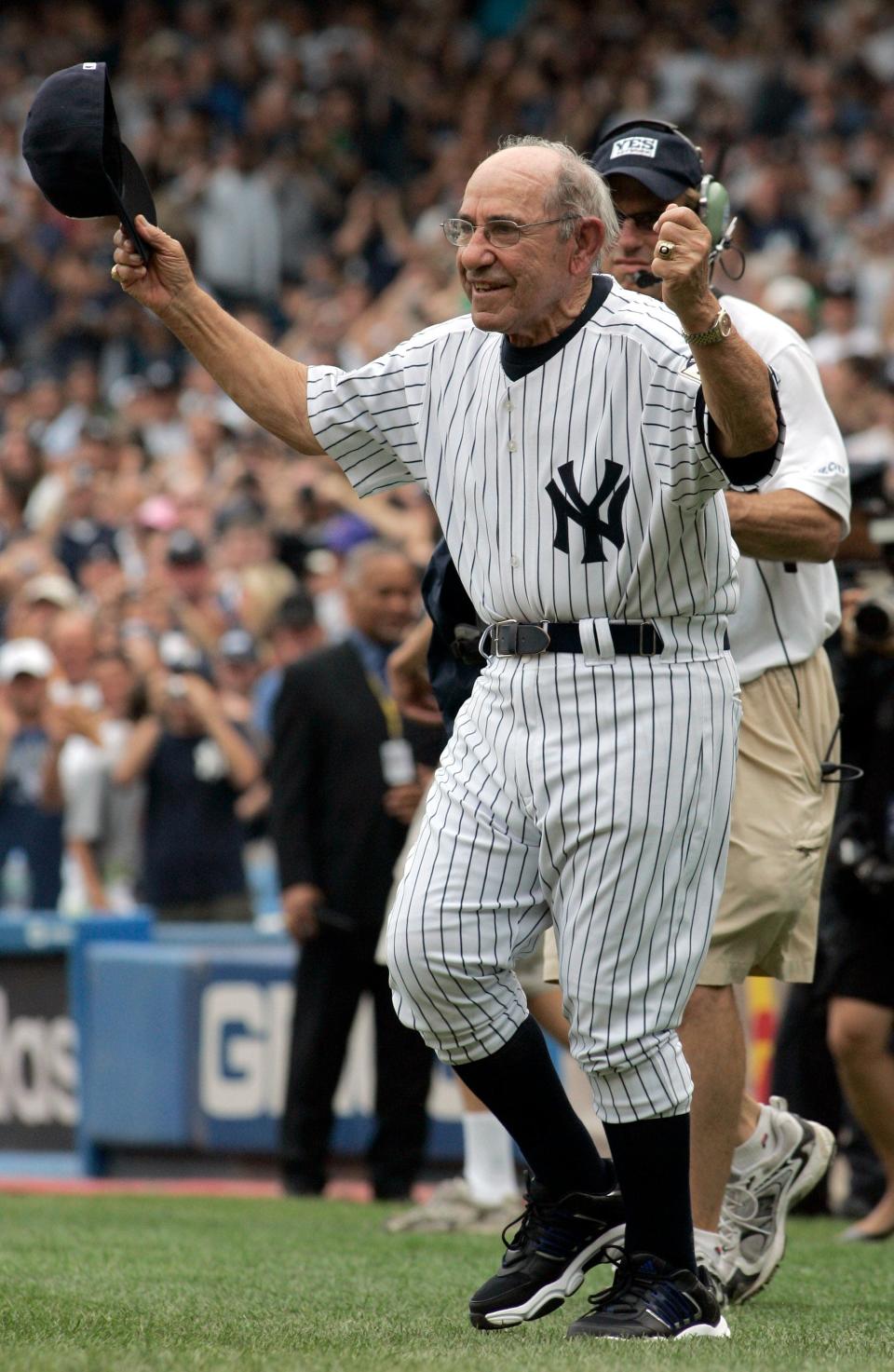 New York Yankees legend Yogi Berra tips his cap to fans during introduction ceremonies at Old Timers' Day at Yankee Stadium, Saturday, Aug. 2, 2008. (AP Photo/Ed Betz)