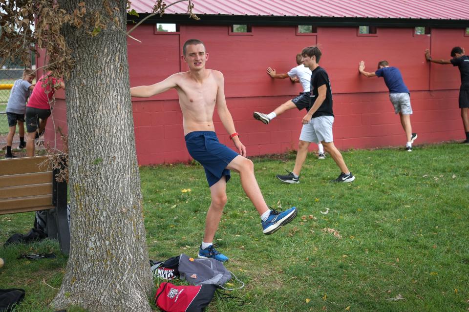 ADM-Adel sophomore cross country runner Brycen Timmer warms up at practice. Timmer, who has autism, is in his first season competing for the high school team.