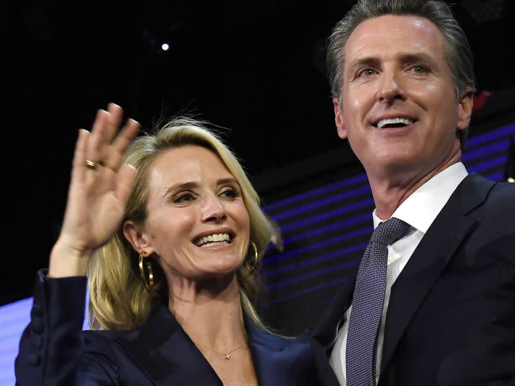 Gavin Newsom and his wife Jennifer Siebel Newsom wave to supporters during an election night event on Nov. 6, 2018, in L.A.