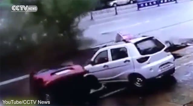 The moment one vehicle begins to fall into the sinkhole. Source: YouTube/CCTVNews.