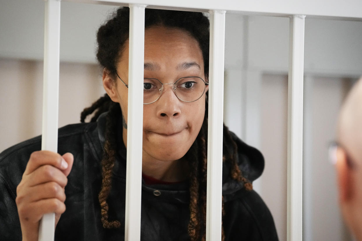 WNBA star and two-time Olympic gold medalist Brittney Griner stands in a cage at a court room prior to a hearing, in Khimki just outside Moscow, Russia, Tuesday, July 26, 2022. American basketball star Brittney Griner has returned to a Russian courtroom for her drawn-out trial on drug charges that could bring her 10 years in prison if convicted. (AP Photo/Alexander Zemlianichenko, Pool)