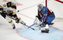 Boston Bruins left wing Nick Foligno, left, has his shot blocked by Colorado Avalanche goaltender Alexandar Georgiev in the first period of an NHL hockey game Wednesday, Dec. 7, 2022, in Denver. (AP Photo/David Zalubowski)