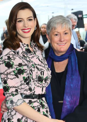 <p>JEAN-BAPTISTE LACROIX/AFP/Getty</p> Anne Hathaway and her mom Kate McCauley Hathaway stand on Hathaway's Star on the Hollywood Walk Of Fame on May 09, 2019.