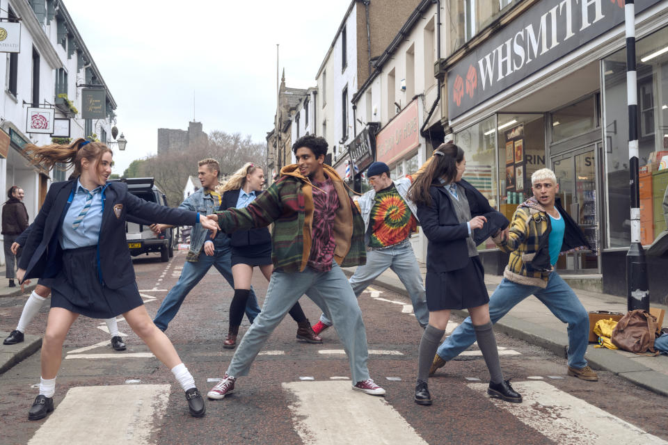 The cast of Greatest Days dancing on a zebra crossing