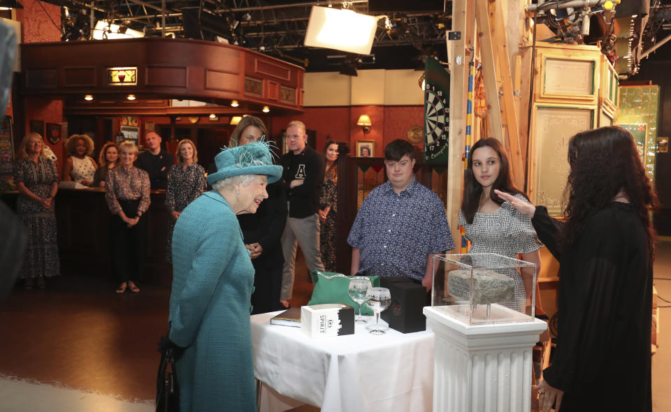 Britain's Queen Elizabeth II meets actors and members of the production team during a visit to the set of the long running television series Coronation Street, in Manchester, England, Thursday July 8, 2021. (AP Photo/Scott Heppell)