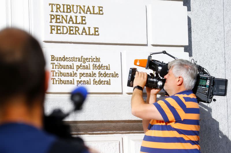 Media members stand outside the Swiss Federal Criminal Court, in Bellinzona