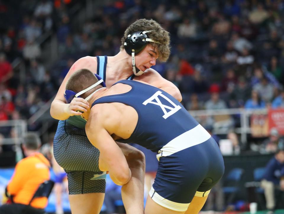 Carmel's Leo Venables wrestles Sachem North's Eric Wetherbee during the preliminary round of the NYSPHSAA wrestling championships at MVP Arena in Albany on Friday, February 25, 2022. 