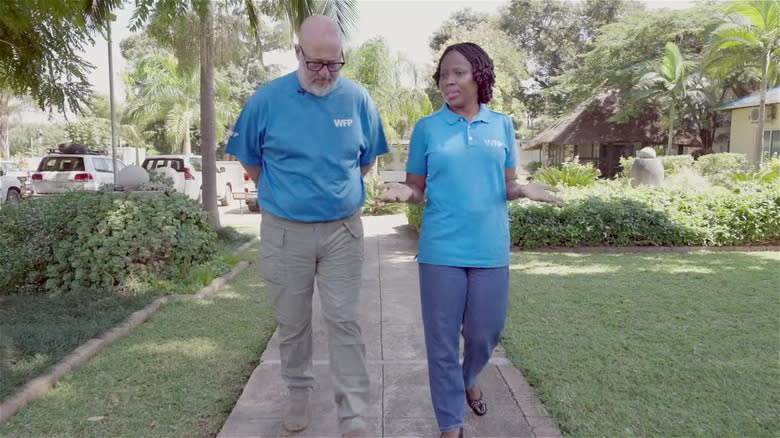 Andrew Zimmern walking with woman