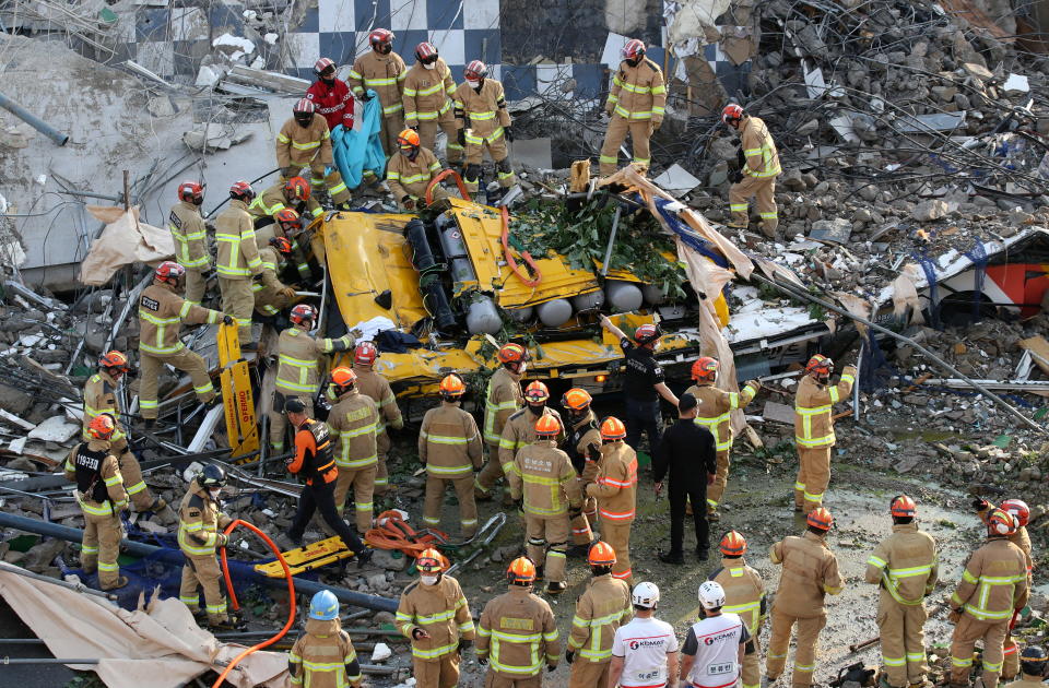 South Korean firefighters search for passengers among the rubble. Source: Reuters