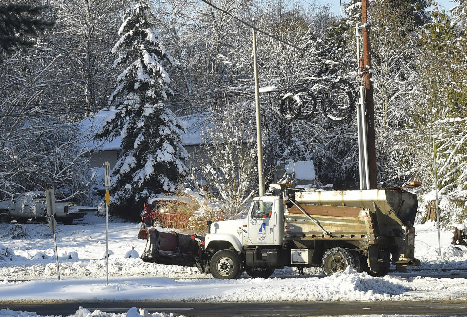 A City of Olympia sanding truck makes it way up a street on Sunday, Feb. 10, 2019, in Olympia, Wash. Pacific Northwest residents who are more accustomed to rain than snow are digging out from a winter storm and bracing for more. (Steve Bloom/The Olympian via AP)