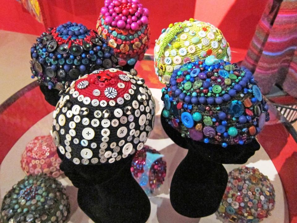 This publicity photo provided by Kaffe Fassett Studio shows textile artist Kaffe Fassett's crocheted skull caps, which are embellished with buttons and beads. Dozens of similar caps appeared in the show "Kaffe Fassett: A Life in Colour" recently at the Fashion and Textile Museum in London. Today’s crochet is leaner and trendier than that of the 1960s and ’70s, from which we know it for its bulky, acrylic yarns and Afghan blankets. (AP Photo/Kaffe Fassett Studio)