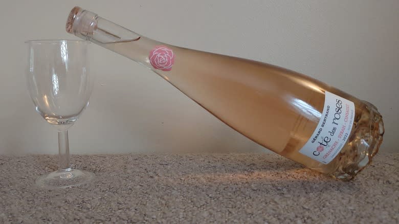 Rosé bottle resting on glass
