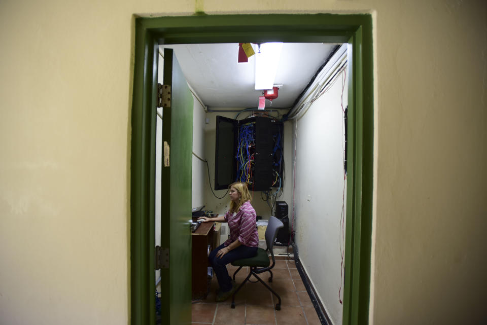 In this Feb. 13, 2019 photo, U.S. Forest Service research ecologist Tana Wood, goes over data collected in the El Yunque tropical rainforest, in Rio Grande, Puerto Rico. The 2017 hurricane season, with Hurricane Maria following a lesser blow from Hurricane Irma, has given researchers a chance as well to see how storms affect the recovery of ecosystems already under stress. (AP Photo/Carlos Giusti)