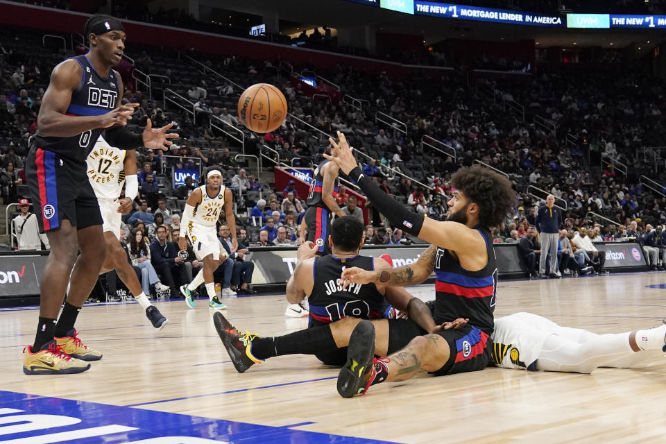 Detroit Pistons forward Isaiah Livers (12) passes to center Jalen Duren (0) during the second half of an NBA basketball game against the Indiana Pacers, Monday, March 13, 2023, in Detroit. (AP Photo/Carlos Osorio)