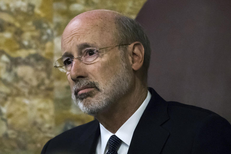 FILE - In this Wednesday, April 10, 2019 file photo, Gov. Tom Wolf listens as Pennsylvania lawmakers come together in an unusual joint session to commemorate the victims of the Pittsburgh synagogue attack that killed 11 people last year at the state Capitol in Harrisburg, Pa. When Pennsylvania Gov. Tom Wolf visits Holocaust memorials in Lithuania and Poland, he'll carry the mezuzah that was outside the office door of Rabbi Jeffrey Myers when a gunman killed 11 people in Pittsburgh's Tree of Life synagogue. Wolf said Friday, Sept. 6, 2019 that he called Myers ahead of his trip to the two countries, where he'll also visit Pennsylvania National Guard troops and meet with Lithuanian President Gitanas Nauseda. (AP Photo/Matt Rourke, File)
