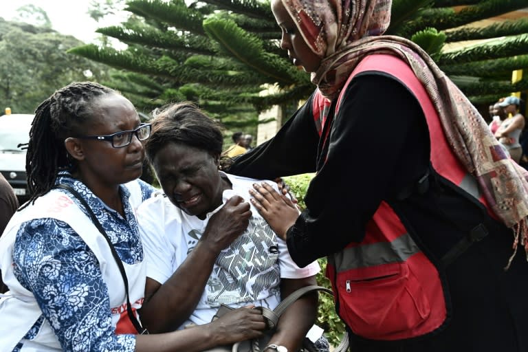 A woman grieves after identifying the body of a loved one