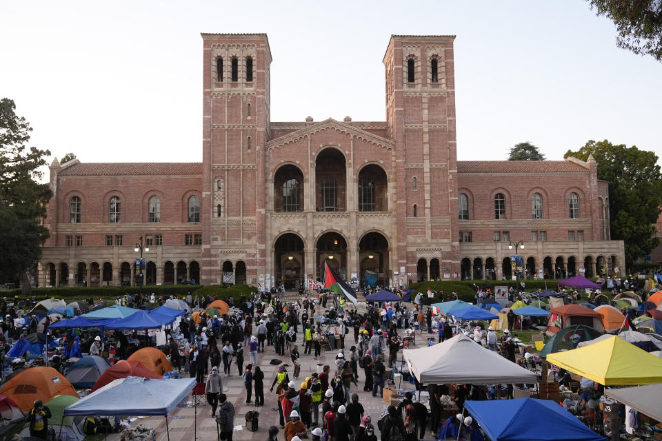 FILE - Demonstrators walk in an encampment on the UCLA campus after clashes between pro-Israel and pro-Palestinian groups, Wednesday, May 1, 2024, in Los Angeles. (AP Photo/Jae C. Hong, File)