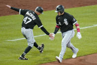 Chicago White Sox's Yasmani Grandal (24) celebrates with third base coach Joe McEwing as he rounds third base after hitting a three-run home run off Pittsburgh Pirates starting pitcher Tyler Anderson during the seventh inning of a baseball game in Pittsburgh, Tuesday, June 22, 2021. (AP Photo/Gene J. Puskar)