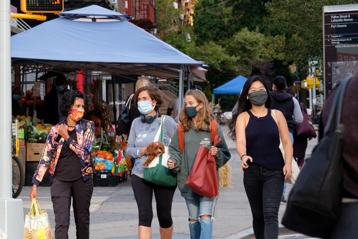 People wear masks to prevent the spread of Covid-19 in the Fort Greene neighborhood of Brooklyn, New York.