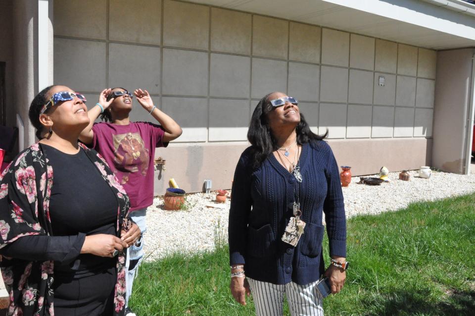 Watching the eclipse at Delaware State University in Dover April 8, 2024 are, from left, professor Lori Crawford, student Tayani Peacock and professor Hazel Bradshaw-Beaumont.